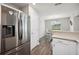 Stainless refrigerator compliments the dining area view from the kitchen at 133 Cloverbrook Trl, Davenport, FL 33837
