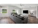 Spacious living room featuring modern decor, a ceiling fan, and wood-look flooring at 133 Cloverbrook Trl, Davenport, FL 33837