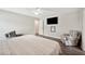 Spacious main bedroom features a ceiling fan, tv, and two patterned armchairs at 133 Cloverbrook Trl, Davenport, FL 33837