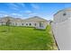 Beautiful backyard with lush green grass, a white fence, and a covered patio, perfect for outdoor living at 1371 Madison Cir, Haines City, FL 33844