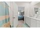 Bathroom view showcases the walk-in shower, tile flooring and doorway view to the bedroom at 1371 Madison Cir, Haines City, FL 33844