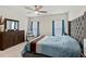 Spacious bedroom featuring a tufted headboard, neutral carpeting, and natural light from two large windows at 1371 Madison Cir, Haines City, FL 33844