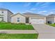 Beautiful single-Gathering home with a well-manicured lawn, modern two-car garage, and inviting entryway at 1371 Madison Cir, Haines City, FL 33844