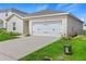 Attached two-car garage with a well-maintained driveway and tidy landscaping at 1371 Madison Cir, Haines City, FL 33844