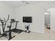Home gym with exercise equipment, television and view to the ensuite bathroom at 1371 Madison Cir, Haines City, FL 33844