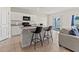 Modern kitchen island with granite countertops, bar stool seating and stainless steel appliances at 1371 Madison Cir, Haines City, FL 33844
