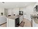 Well-appointed kitchen featuring granite countertops, tile flooring, and modern black appliances at 1371 Madison Cir, Haines City, FL 33844