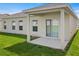 Covered patio with sleek sliding glass door and windows, offering a seamless transition to the outdoors at 1371 Madison Cir, Haines City, FL 33844