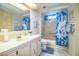 Charming bathroom featuring blue accents, a tub/shower combo, and ample counter space at 1610 Reynolds Rd # 204, Lakeland, FL 33801