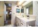 Well-lit bathroom features a vanity with storage and a decorative wallpaper at 1610 Reynolds Rd # 204, Lakeland, FL 33801