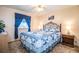 Relaxing bedroom showcasing a decorative bed frame with blue bedding and matching window treatments at 1610 Reynolds Rd # 204, Lakeland, FL 33801