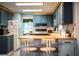Cozy kitchen featuring blue cabinets, butcher block countertops and an adjacent breakfast bar with seating at 1610 Reynolds Rd # 204, Lakeland, FL 33801