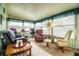 Sunroom with plenty of seating, including multiple recliners and a desk for flexible space and relaxation at 1610 Reynolds Rd # 204, Lakeland, FL 33801