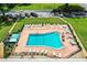 Aerial view of a pool with surrounding lounge chairs and green space, perfect for community recreation at 1610 Reynolds Rd # 204, Lakeland, FL 33801