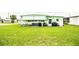 View of the side of the home with a well-maintained lawn and outdoor utilities at 1610 Reynolds Rd # 204, Lakeland, FL 33801