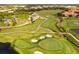 Aerial perspective of the Grasslands golf course with lush landscaping and serene water elements at 1739 Laurel Glen Pl, Lakeland, FL 33803