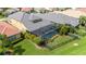 Aerial view of the home, showcasing the backyard, enclosed pool, landscaping, and neighborhood at 1739 Laurel Glen Pl, Lakeland, FL 33803