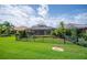 Expansive backyard with green grass, trees, garden, and enclosed pool area at 1739 Laurel Glen Pl, Lakeland, FL 33803
