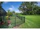 Lush backyard with green grass, trees, garden, and fencing at 1739 Laurel Glen Pl, Lakeland, FL 33803