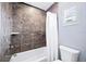 A well-maintained bathroom includes a tiled shower/tub, white fixtures, and a window, providing a comfortable and functional space at 1739 Laurel Glen Pl, Lakeland, FL 33803