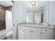 A bright bathroom featuring a granite vanity, a large mirror, and a shower/tub combination, offering a blend of style and functionality at 1739 Laurel Glen Pl, Lakeland, FL 33803