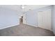 This spacious bedroom features plush carpeting, neutral walls, a ceiling fan, and ample closet space, creating a comfortable living space at 1739 Laurel Glen Pl, Lakeland, FL 33803