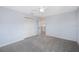 A carpeted bedroom has neutral walls, ceiling fan, double closet and an open doorway at 1739 Laurel Glen Pl, Lakeland, FL 33803