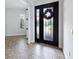 Inviting foyer with tile flooring, a decorative front door, and view into adjacent rooms at 1739 Laurel Glen Pl, Lakeland, FL 33803
