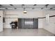 Spacious garage with epoxy floors, storage cabinets, and room for vehicles and projects at 1739 Laurel Glen Pl, Lakeland, FL 33803