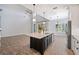 Bright, open kitchen with a large island, stainless steel appliances, and elegant pendant lighting at 1739 Laurel Glen Pl, Lakeland, FL 33803