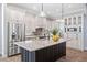 Elegant kitchen featuring stainless steel appliances, a large island, and custom cabinetry at 1739 Laurel Glen Pl, Lakeland, FL 33803