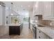 Modern kitchen with granite countertops, stainless steel appliances, and bright white cabinetry at 1739 Laurel Glen Pl, Lakeland, FL 33803