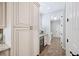 Elegant kitchen with a mini fridge, custom cabinets and views of a well-lit hallway at 1739 Laurel Glen Pl, Lakeland, FL 33803