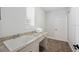 This functional laundry area is equipped with a sink, granite countertops, and storage, making chores convenient and organized at 1739 Laurel Glen Pl, Lakeland, FL 33803