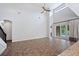 Open living room with high ceilings, tile floors, and access to the pool area at 1739 Laurel Glen Pl, Lakeland, FL 33803