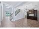 Expansive living space with staircase, decorative cabinet, and views to the pool area at 1739 Laurel Glen Pl, Lakeland, FL 33803