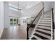 Bright living room with high ceilings, pool view, and elegant staircase with wood and iron details at 1739 Laurel Glen Pl, Lakeland, FL 33803