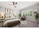 Bright main bedroom featuring neutral tones, large windows, and stylish furnishings creating a comfortable retreat at 1739 Laurel Glen Pl, Lakeland, FL 33803