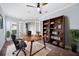 Bright office with desk, chair, and a beautiful wood bookcase filled with books and plants for a warm, productive space at 1739 Laurel Glen Pl, Lakeland, FL 33803