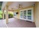 Covered patio with ceiling fans and access to the pool through French doors at 1739 Laurel Glen Pl, Lakeland, FL 33803