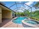 Enclosed pool and spa featuring tiled accents and located just outside of the home's exterior at 1739 Laurel Glen Pl, Lakeland, FL 33803