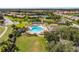 Aerial view showcasing a beautiful pool area, tennis courts, and surrounding residential homes at 1739 Laurel Glen Pl, Lakeland, FL 33803