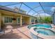 Enclosed pool and spa featuring a brick deck, an attached covered patio, and view of the home's exterior at 1739 Laurel Glen Pl, Lakeland, FL 33803
