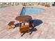 Wooden table and chairs poolside with brick pavers, surrounded by lounge chairs and a pool at 1739 Laurel Glen Pl, Lakeland, FL 33803