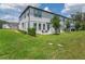 A wide view of the backyard highlighting green grass and neighboring units at 1754 Sanibel Dr, Davenport, FL 33896