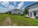 Scenic backyard view showing lush green grass, neighboring houses, and blue sky at 1754 Sanibel Dr, Davenport, FL 33896