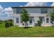 Backyard view of townhome with green grass, patio, and blue door at 1754 Sanibel Dr, Davenport, FL 33896