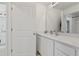 Clean and modern bathroom featuring a white vanity and a large mirror for daily convenience at 1754 Sanibel Dr, Davenport, FL 33896