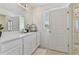 Well-lit bathroom with modern white vanity, and a large mirror and bright natural light at 1754 Sanibel Dr, Davenport, FL 33896