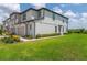 Beautiful two-story townhouse with manicured lawn and neutral tones offers a welcoming curb appeal at 1754 Sanibel Dr, Davenport, FL 33896